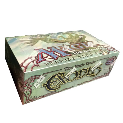 Opened booster box showing sealed Exodus booster packs and collectible card sleeves arranged on a tabletop